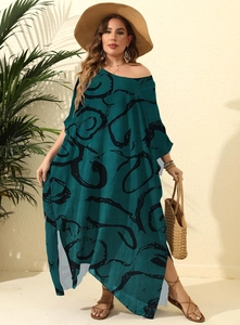 Detail view of side slit and abstract ink print on this green maxi summer dress