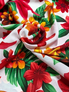 Dettaglio ravvicinato del tessuto in chiffon tropicale con ibisco e foglie di palma