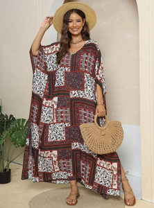 Close-up of bohemian maxi dress featuring ethnic patchwork prints and light kaftan fabric