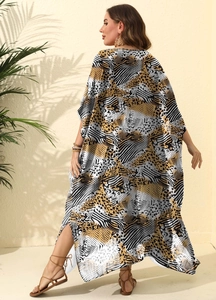 Detail of printed maxi beach dress with high side slit and mixed animal print patterns