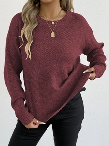 Detailed macro view of wine red waffle knit texture and ribbed crew neckline on a sweater