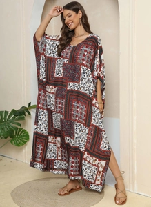 Detailed view of the V-neckline and intricate ethnic paisley print on a loose maxi dress