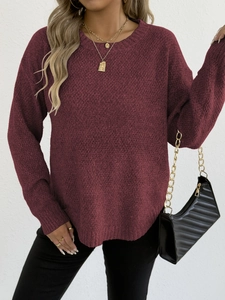 Detail of the crewneck and burgundy textured knit fabric on this long sleeve sweater