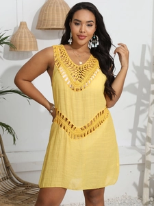 Close-up of bohemian bright yellow crochet hollow-out details on a sleeveless beach dress
