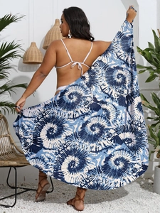 Detail of blue and white abstract floral print sarong styled with a white bikini on a model