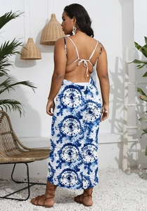 Back view of a blue and white tie-dye backless maxi dress with cross strap details