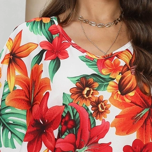 Detailed view of the vibrant floral print neckline on a tropical summer kaftan