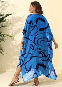 Rear view of long blue ink print dress with side slits and abstract swirl patterns