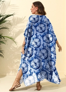 Detail of high side slit and blue tie-dye pattern on a loose kaftan beach dress