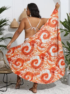Detail view of the orange and white sunburst print on the lightweight sarong wrap