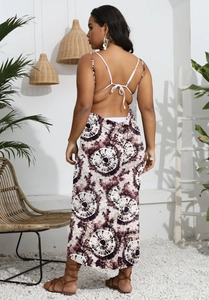 Detail of bohemian backless maxi dress with brown tie-dye print and thin straps