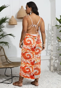 Detail of cross-back tie design on backless orange and white print maxi dress