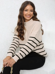 Detail of soft cream striped knit sweater with stand-up collar and metal zipper
