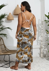 Detail of backless leopard print maxi dress with thin straps for beach vacation