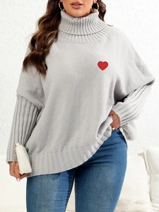 Detail of red heart patch embroidery on high collar grey knitted oversized sweater