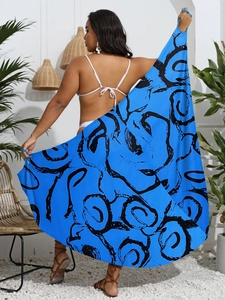 Outdoor shot of a plus size woman holding a blue floral sarong wrap with a white bikini