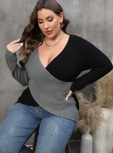 Detailed knit texture of a two-tone grey and black deep V-neck wrap style sweater