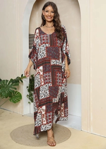 Close-up detail of bohemian patchwork print on a loose-fitting ethnic kaftan maxi dress