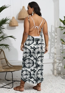 Close-up of the backless tie-up design and bohemian print on a summer beach maxi dress