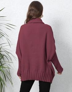 Detail of burgundy oversized turtleneck sweater featuring heavy-knit ribbed cuffs and hem