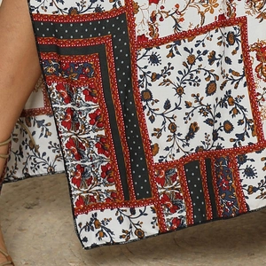 Detailed close-up of bohemian ethnic floral and geometric pattern on high-quality fabric