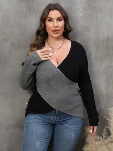 Detail of a deep V-neck wrap sweater with gray and black contrast color block panels