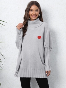 Detail of red heart embroidery on gray turtleneck oversized knit sweater for women