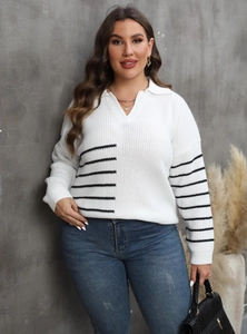 Detailed view of women's plus size white knit sweater featuring black striped contrast sleeves