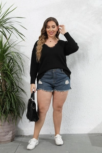 Detail of plus size V-neck sweater with elegant black lace trim and knitted texture