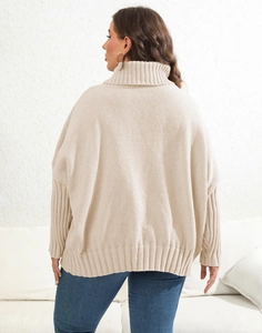 Macro detail of beige turtleneck sweater featuring rib-knit cuffs and premium fabric texture