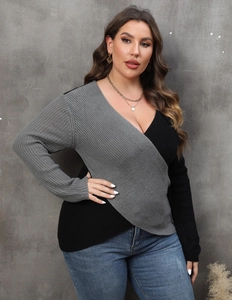 Detail of plus size wrap sweater showing bicolor grey and black waffle knit texture