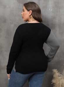 Detail of plus size color block knit sweater showing black and grey contrast textures