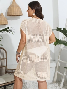Detail of knit mesh pattern and side slit on cream white beach cover-up cardigan