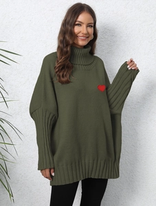 Detail of olive green knit sweater featuring a high neck and red heart embroidery