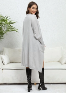Detailed view of light gray knit cardigan with ribbed cuffs and large side pockets