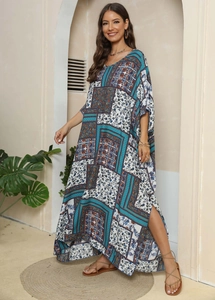 Detail of high side slit on bohemian floral print maxi dress with geometric patterns