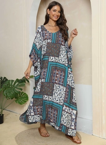 Detailed pattern of ethnic print maxi dress with blue, white and orange floral motifs