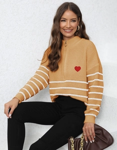 Detail of ginger knit sweater with white stripes and red heart embroidery on chest
