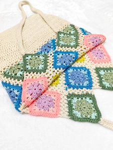 Bohemian crochet halter top with colorful grandma square patchwork on white plush background