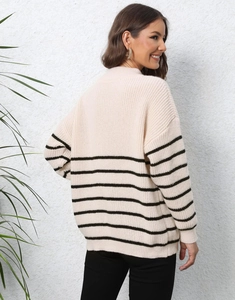 Detailed knit texture of cream oversized striped sweater with a mock neck and zipper
