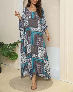 Close-up of bohemian kaftan dress with ethnic geometric floral print and batwing sleeves