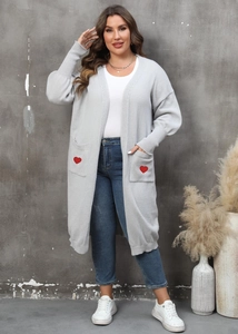 Detailed view of red heart embroidery on light gray knit cardigan pockets with pockets