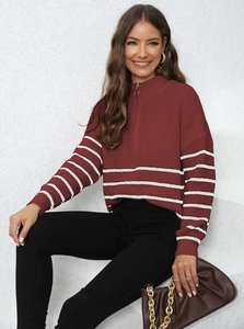 Detail of burgundy striped knit sweater with half-zip collar and ribbed texture