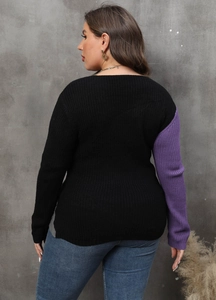 Detail of plus size long sleeve sweater showing black and purple color block knit texture