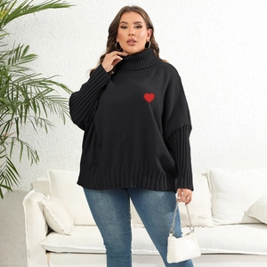 Detail of oversized black turtleneck sweater with red heart embroidery on the chest