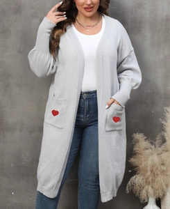 Detail of grey knitted cardigan with large front pockets and red heart embroidery detail