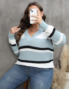 Detail of the V-neckline and striped knit texture on this oversized winter sweater