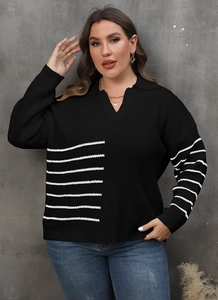 Detail of a black long-sleeved polo sweater with white stripes and V-neckline texture