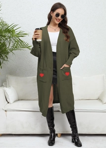 Detailed view of knitted army green cardigan featuring red heart patches on side pockets