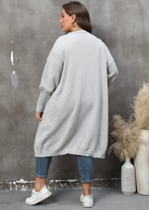 Detail of grey knit cardigan featuring chunky knit texture and ribbed lantern sleeve cuffs